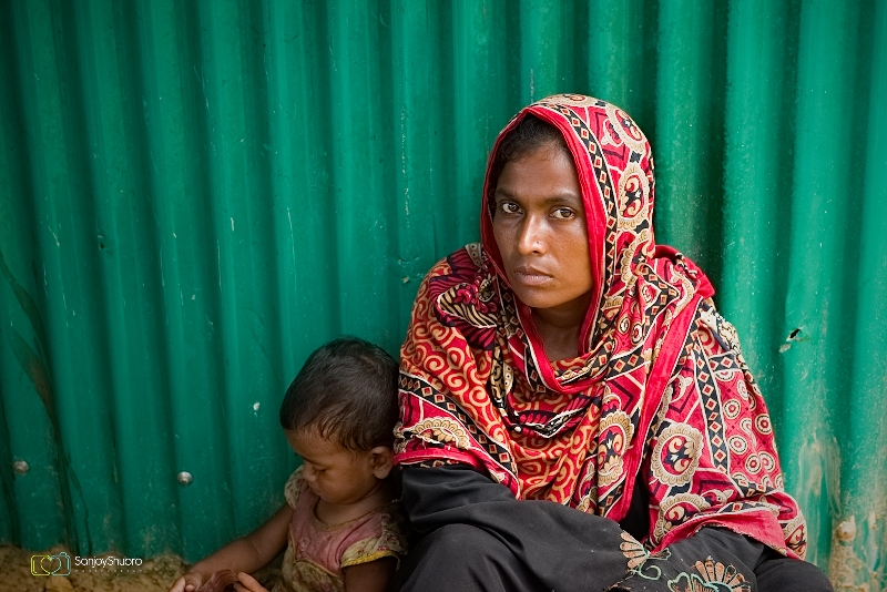 A rohingya muslim refugee woman waiting outside registration camp in Kotupalong camp, Ukiya, Teknaf, Bagnladesh